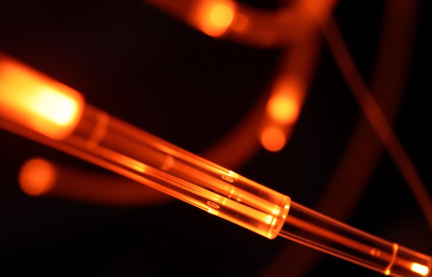 Glowing fibre-optic cables representing high-speed digital communication